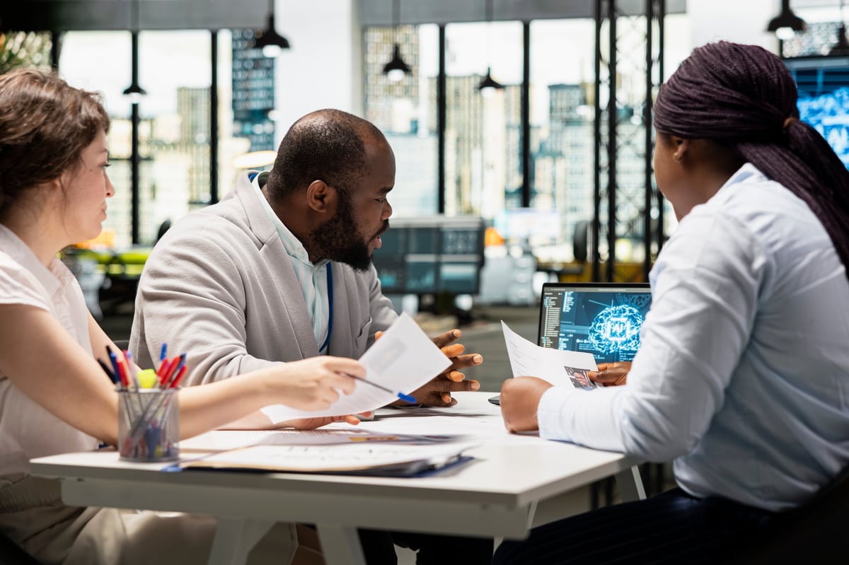 Recruiters reviewing feedback from artificial intelligence platform, using automation and deep learning to make informed hiring decisions