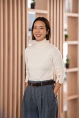 Smiling asian woman wearing a turtleneck