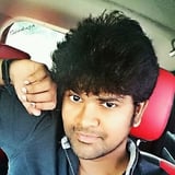 Young man with dark styled hair wearing dark hoodie